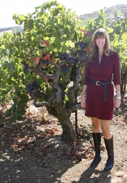 Burgundy dress, tall boots, chunky gold chain necklace 